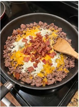 Ground beef, bacon, ranch seasoning, and cheddar filling in a skillet