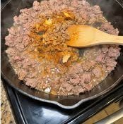 Ground beef cooking with taco seasoning